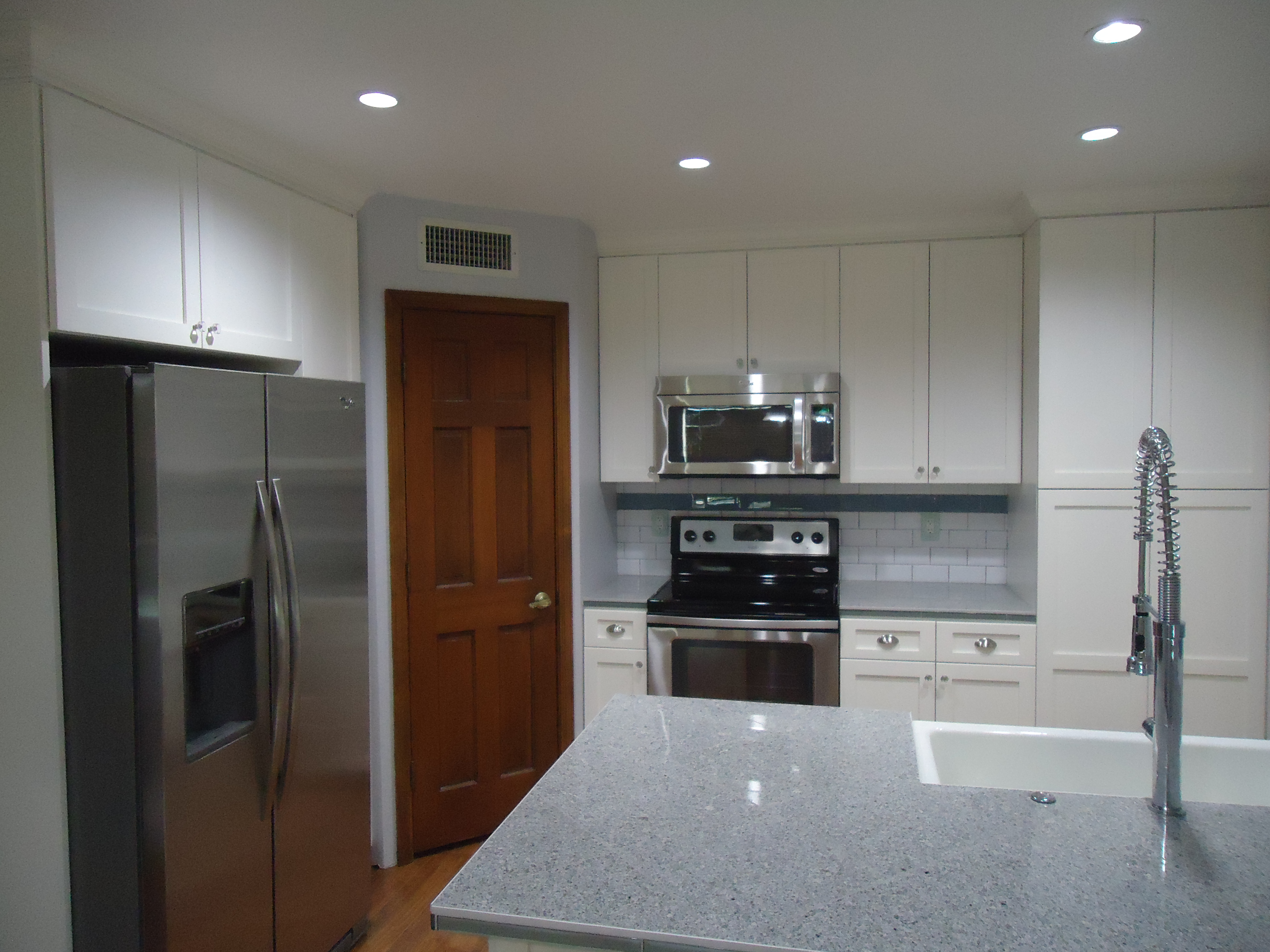 Side view remodeled kitchen island and upgraded appliances