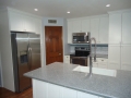 White and gray upgraded kitchen with crown moulding in AZ